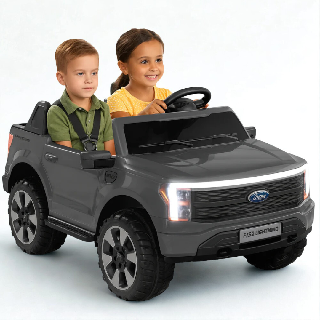 Two kids enjoying a ride in a 24V Ford F-150 kids ride-on truck, featuring realistic design and spacious cabin.