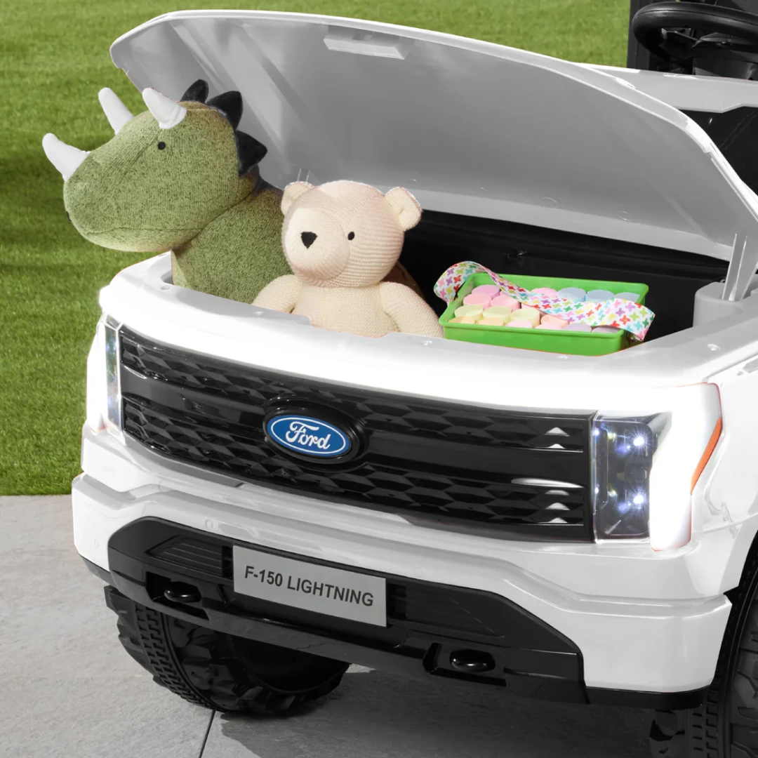 24V Ford F-150 kids ride-on truck with plush toys in the front storage.