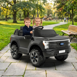 Two children happily riding in a 24V Ford F-150 kids ride-on truck in a park.